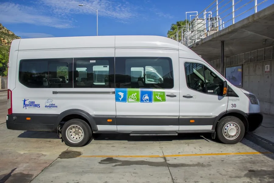 Cabo Adventures shuttle van parked curbside for hotel pickup service in Los Cabos